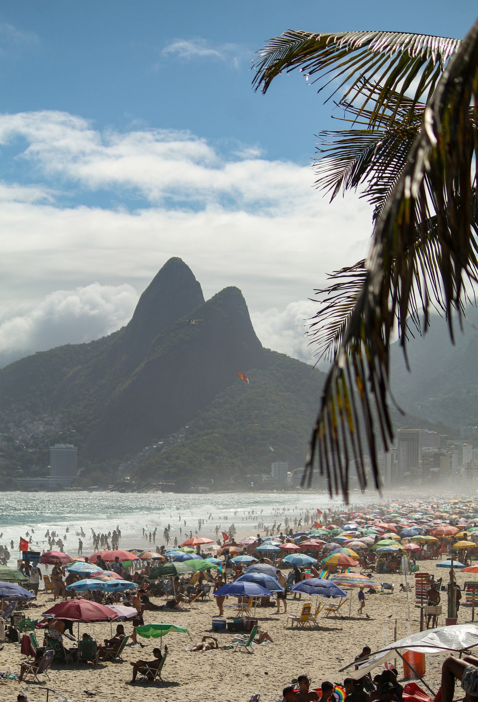 Ipanema Beach with ocean waves and mountains in Rio de Janeiro